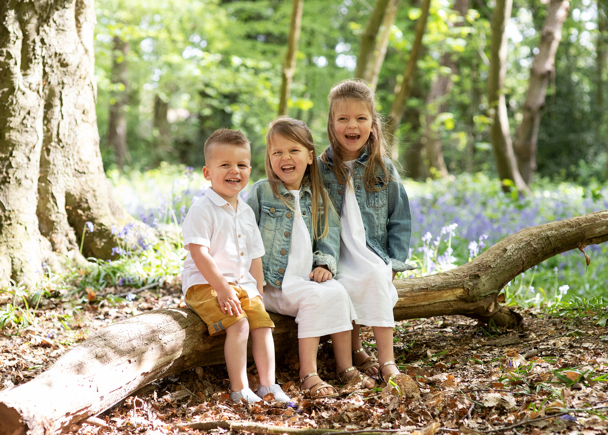 outdoor family photoshoot boy and two girls in bluebells