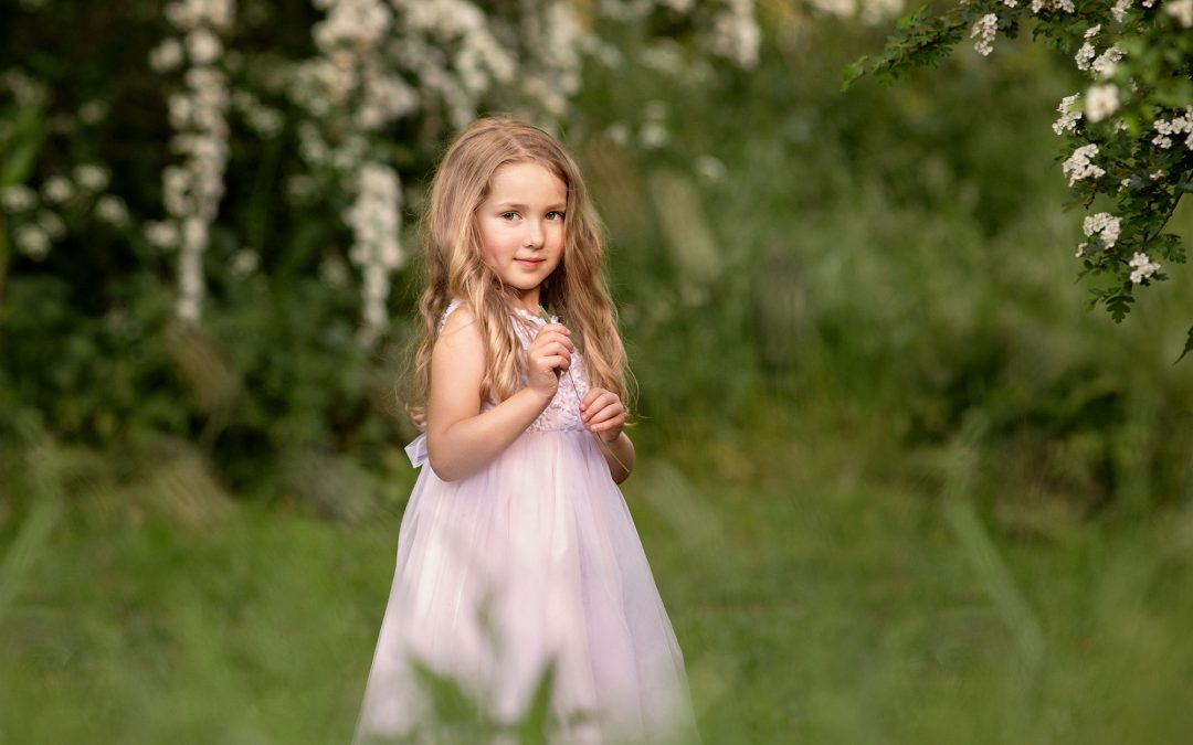 girl in blossom tree during a kent outdoor photoshoot