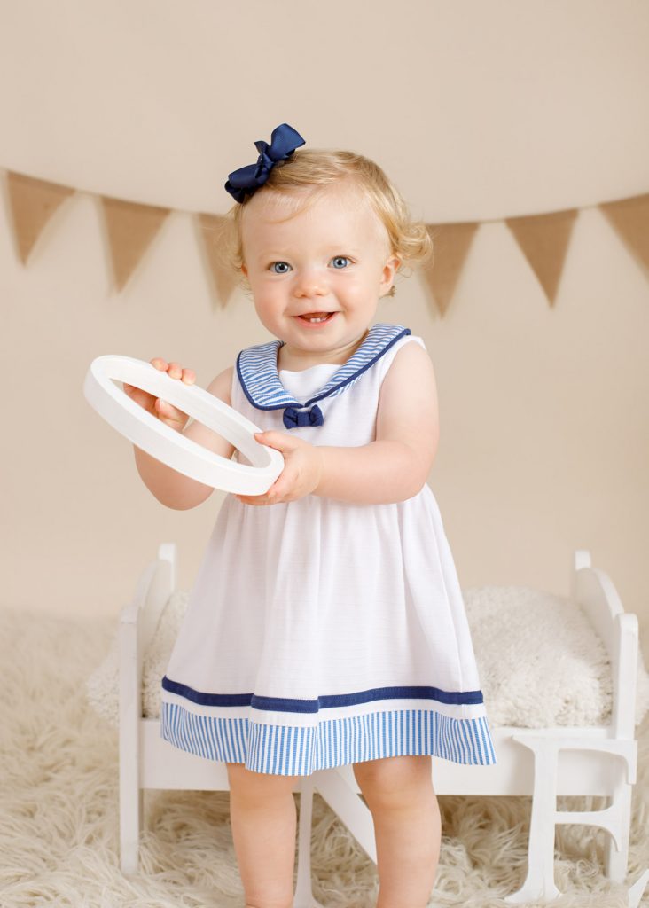 girl on her first birthday photoshoot holding letter photographed in Kent