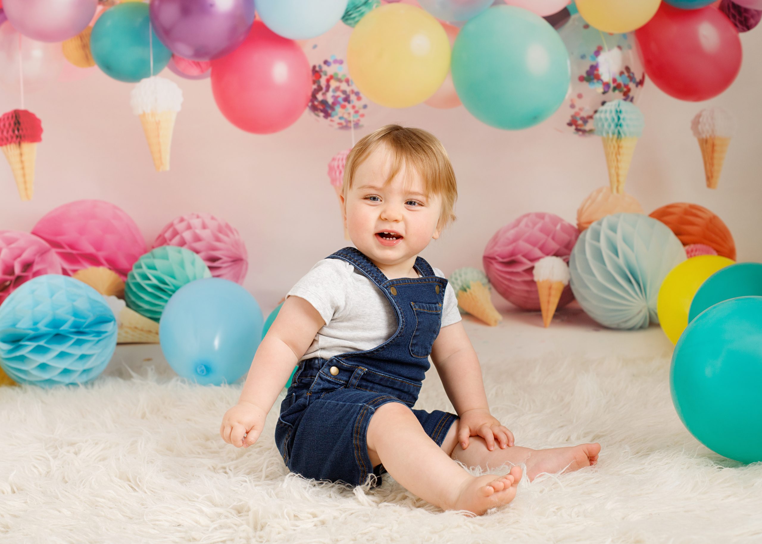boy sitting on rug with balloons taken by Chatham photographer