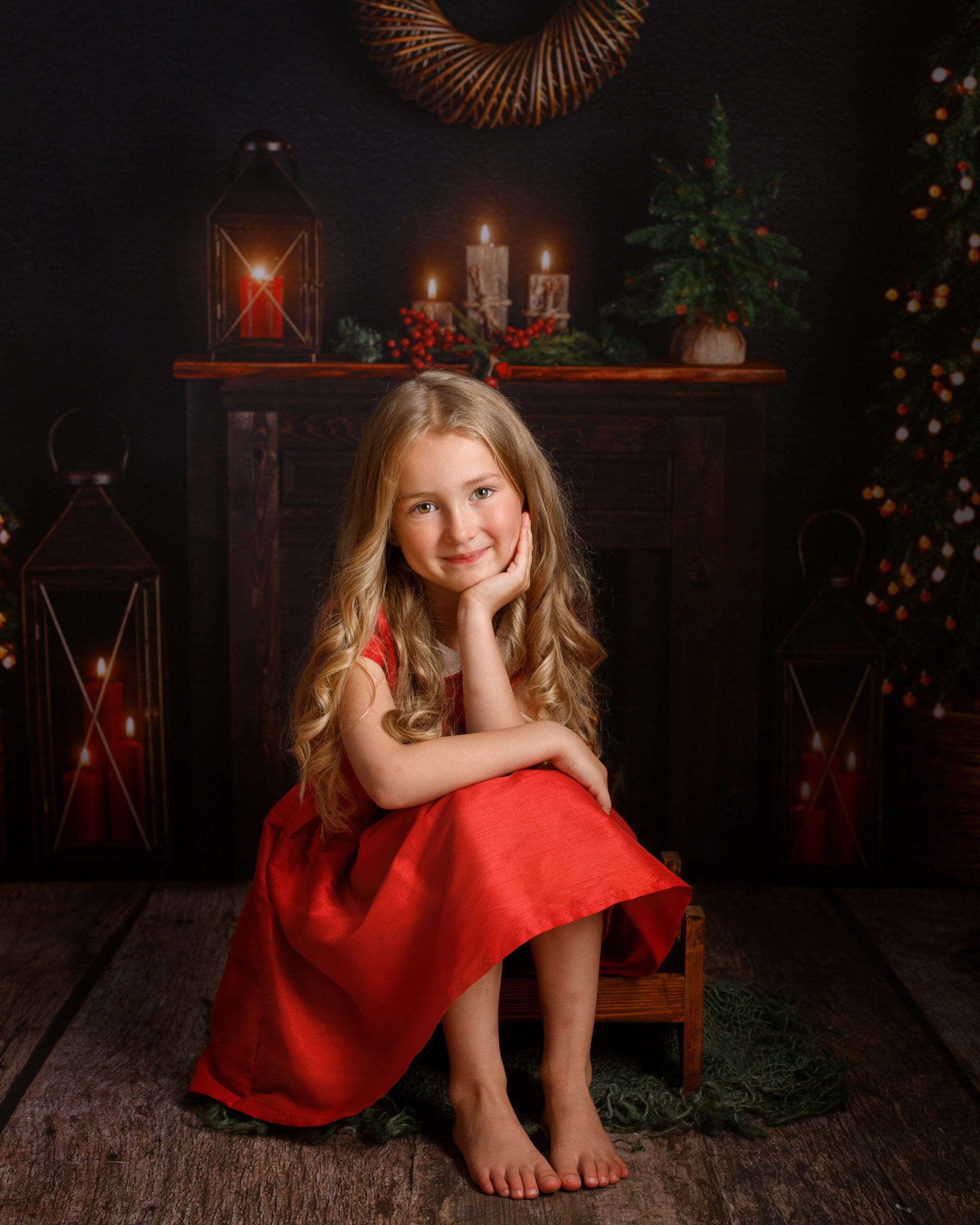 girl in red dress posing for Christmas photoshoot in kent