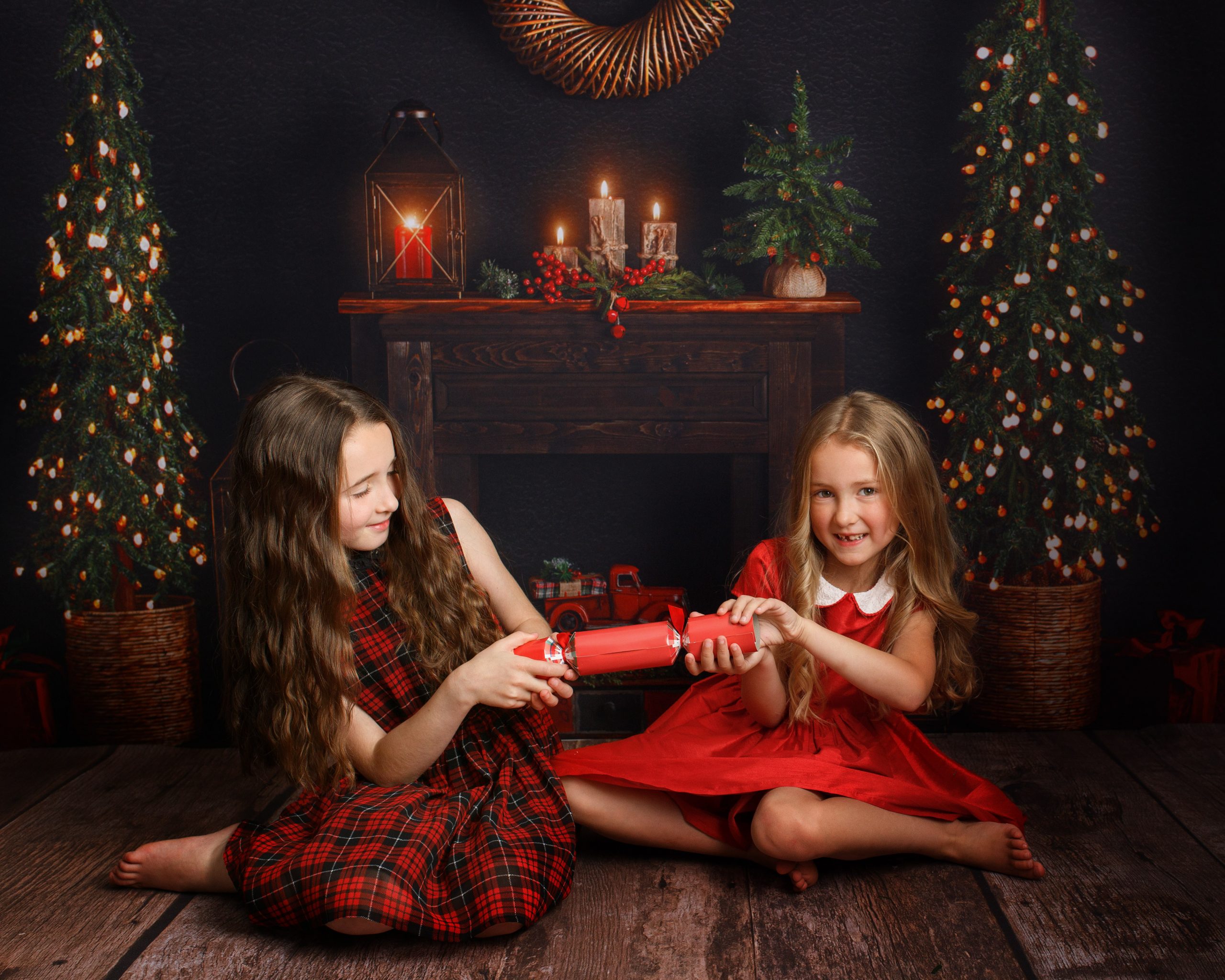 two girls pulling Christmas cracker during a photoshoot in Kent