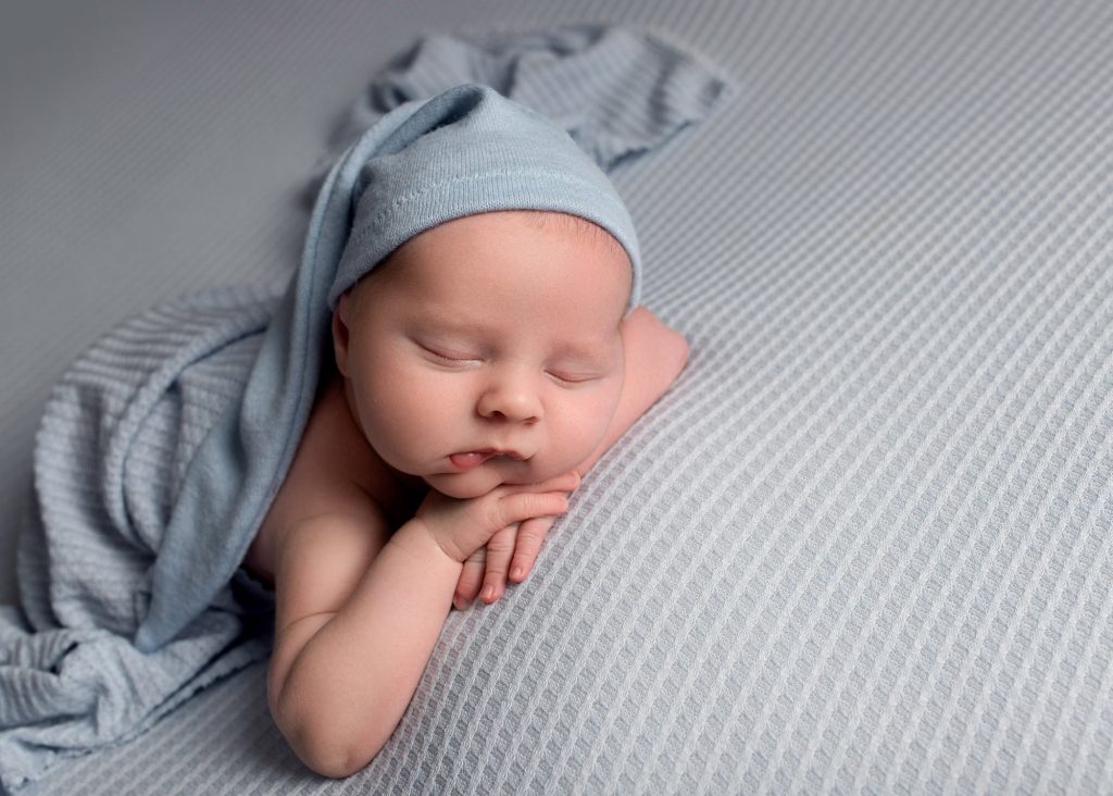 newborn baby boy laying on a blue blanket photographed in Kent