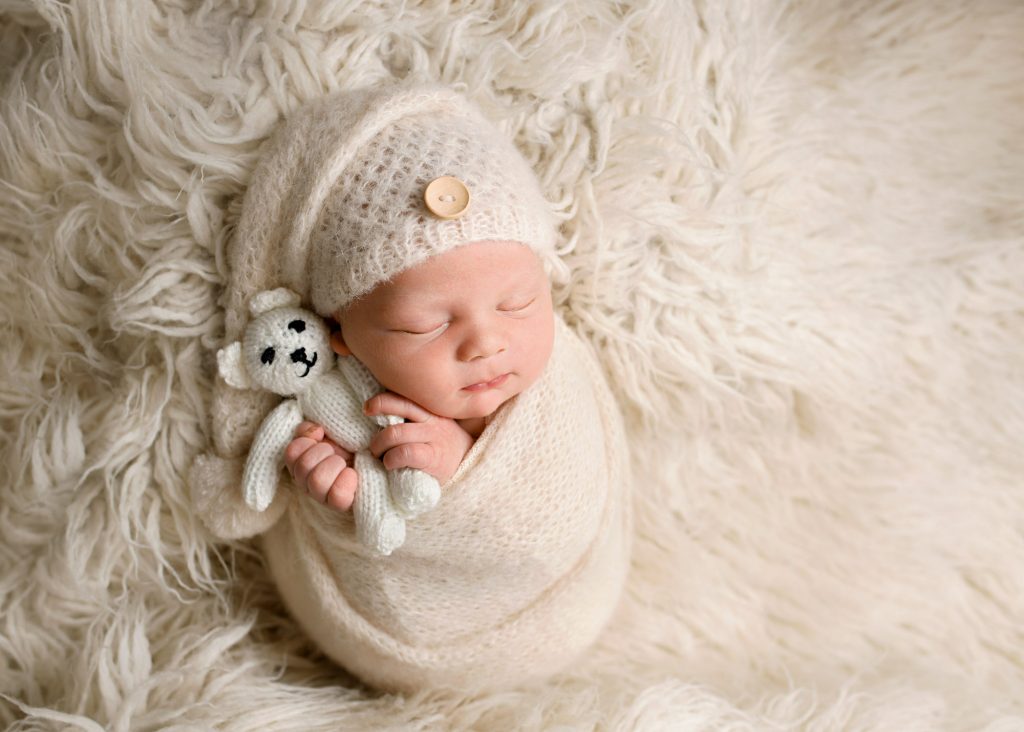 baby boy cuddling a teddy during a photography session in Chatham