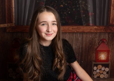 Girl smiling at camera during a Christmas photoshoot in Kent
